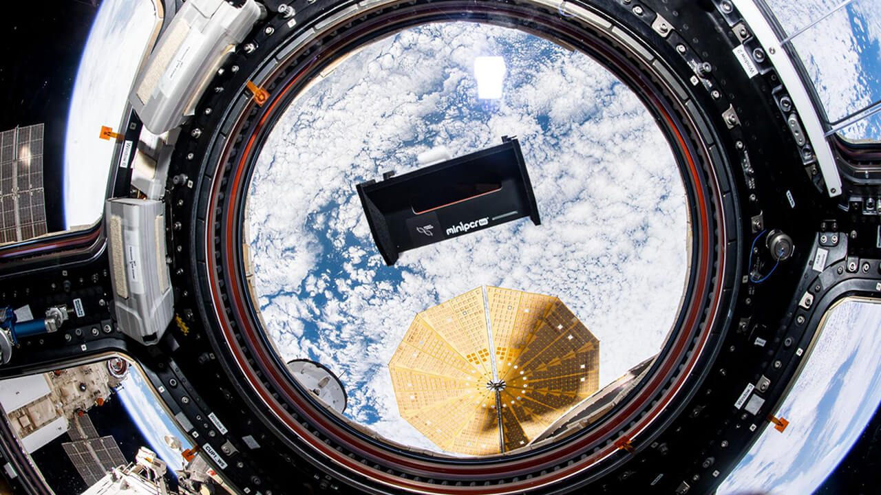 iss065e341636 (9 2 2021) A view of the Genes in Space 8 Fluorescence Viewer floating in front of the Cupola module window aboard the International Space Station (ISS). Genes in Space 9 evaluates low cost and portable BioBits cell free technology as well as two biological sensors aboard the International Space Station (ISS).