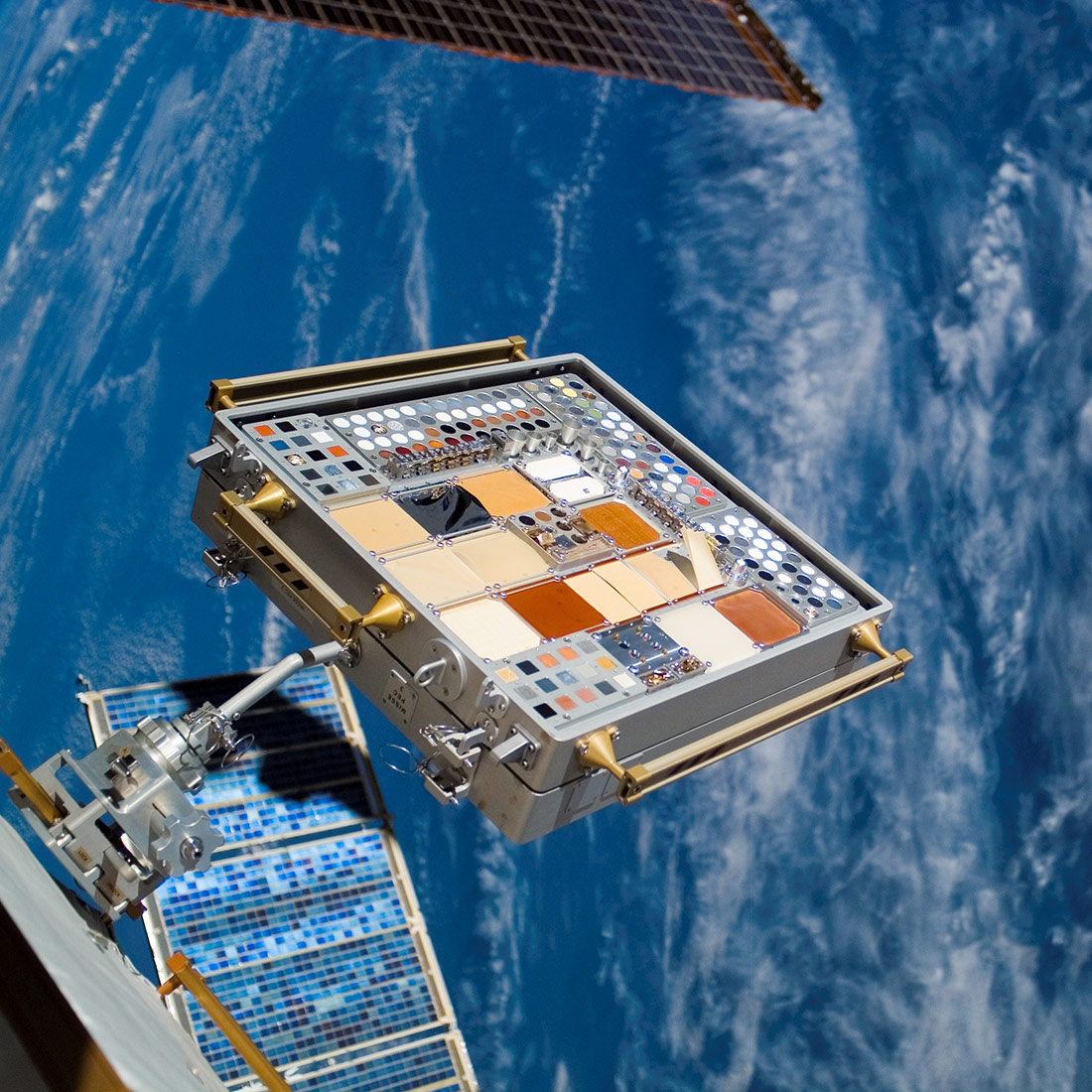 Backdropped by a blue and white Earth, a Materials International Space Station Experiment (MISSE) on the exterior of the station is featured in this image photographed by a crewmember during the STS 118 missions second planned session of extravehicular activity (EVA). MISSE collects information on how different materials weather in the environment of space.