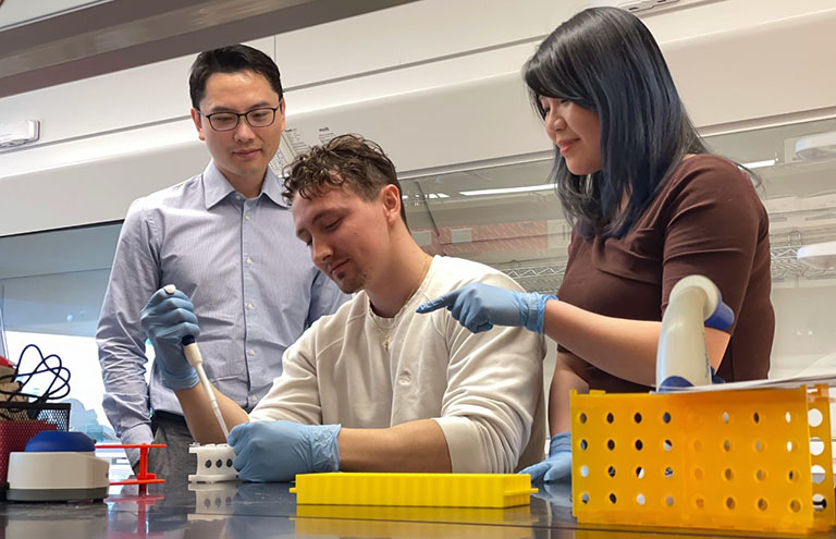 From left: Yupeng Chen, and his PhD students, Ian Sands and Anne Yau, work on the cartilage experiment before flight.