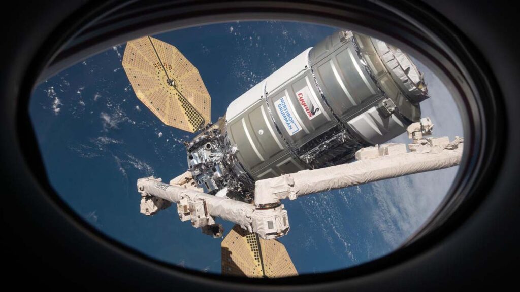 ng20-cygnus-window-1 The Cygnus space freighter from is pictured with the Canadarm2 robotic arm in February 2022.
