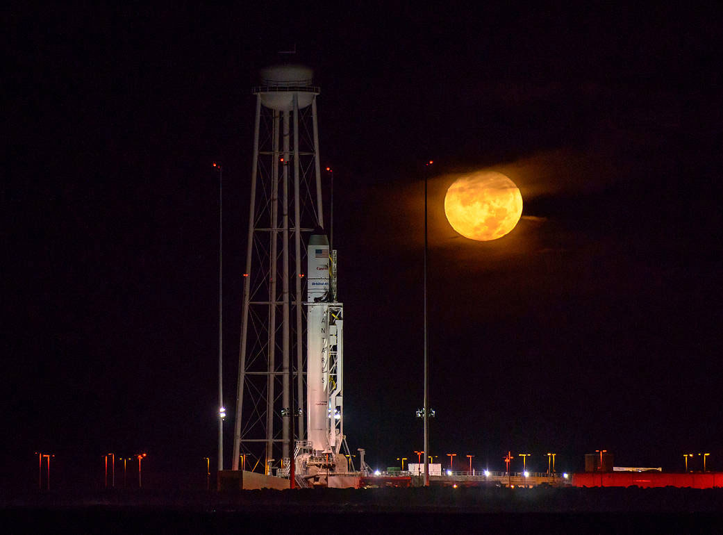 The Orbital ATK Antares rocket, with the Cygnus spacecraft onboard, is seen on launch Pad 0A as the moon sets, predawn, Saturday, Oct. 15, 2016 at NASAs Wallops Flight Facility in Virginia. Orbital ATKs sixth contracted cargo resupply mission with NASA to the International Space Station will deliver over 5,100 pounds of science and research, crew supplies and vehicle hardware to the orbital laboratory and its crew. Launch of Orbital ATKs Antares rocket and Cygnus cargo spacecraft is proceeding as scheduled for a 7:40 p.m. EDT liftoff Monday evening, Oct. 17.