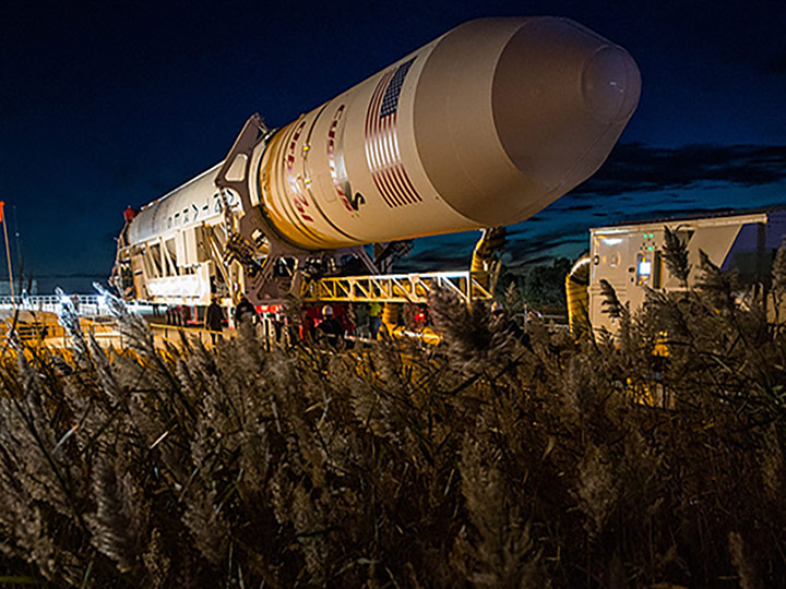 The Orbital Sciences Corporation Antares rocket, with the Cygnus spacecraft onboard, arrives at launch Pad 0A, Friday, Oct. 24, 2014, at NASAs Wallops Flight Facility in Virginia. The Antares will launch with the Cygnus spacecraft filled with over 5,000 pounds of supplies for the International Space Station, including science experiments, experiment hardware, spare parts, and crew provisions. The Orbital 3 mission is Orbital Sciences third contracted cargo delivery flight to the space station for NASA.