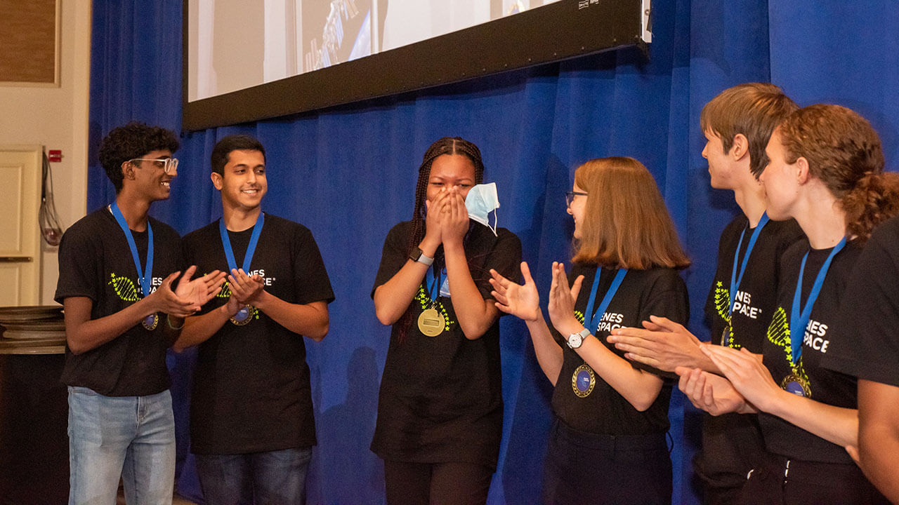 We have a winner! Pristine Onuoha (center) reacts to being announced as the 2022 winner of the Genes in Space competition.