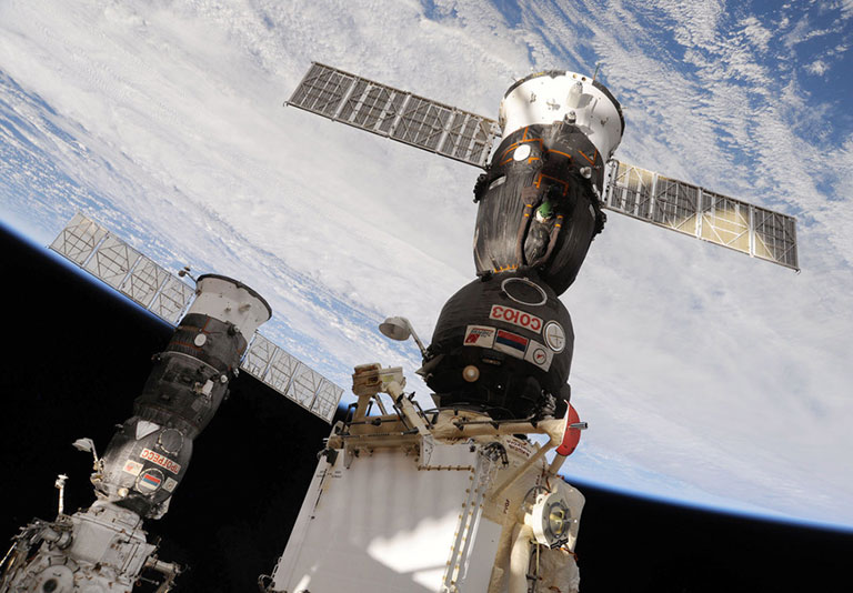 In this photo from 2010, the Progress 37 resupply vehicle (left) is docked to the Pirs module and the Soyuz TMA 19 spacecraft (right) is docked to the Rassvet module.