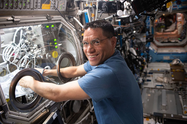 Frank rubio works in the microgravity science glovebox on an investigation to synthesize graphene aerogel in space.
