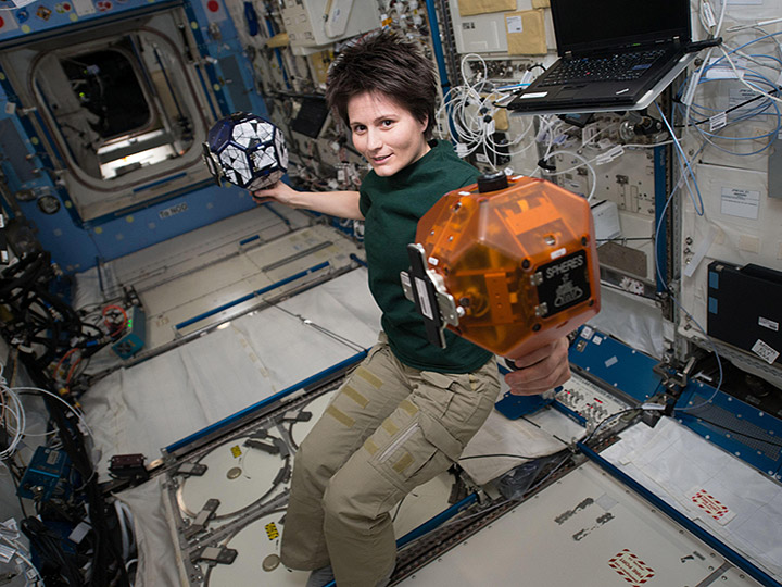 ESA astronaut Samantha Cristoforetti with SPHERES robots onboard the ISS.