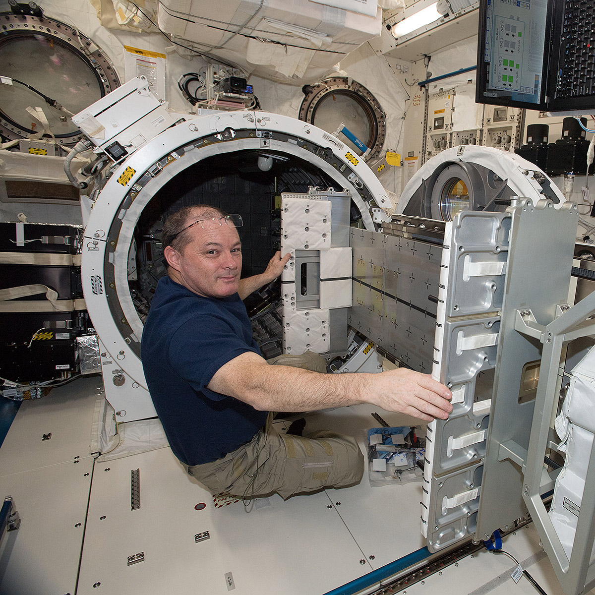 NASA astronaut Scott Tingle works within the Japanese Experiment Module airlock.