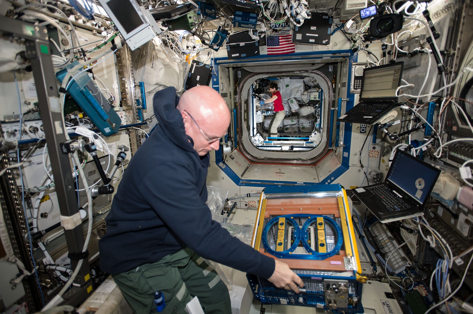 NASA Astronaut Scott Kelly handling the Rodent Research Facility onboard the International Space Station.