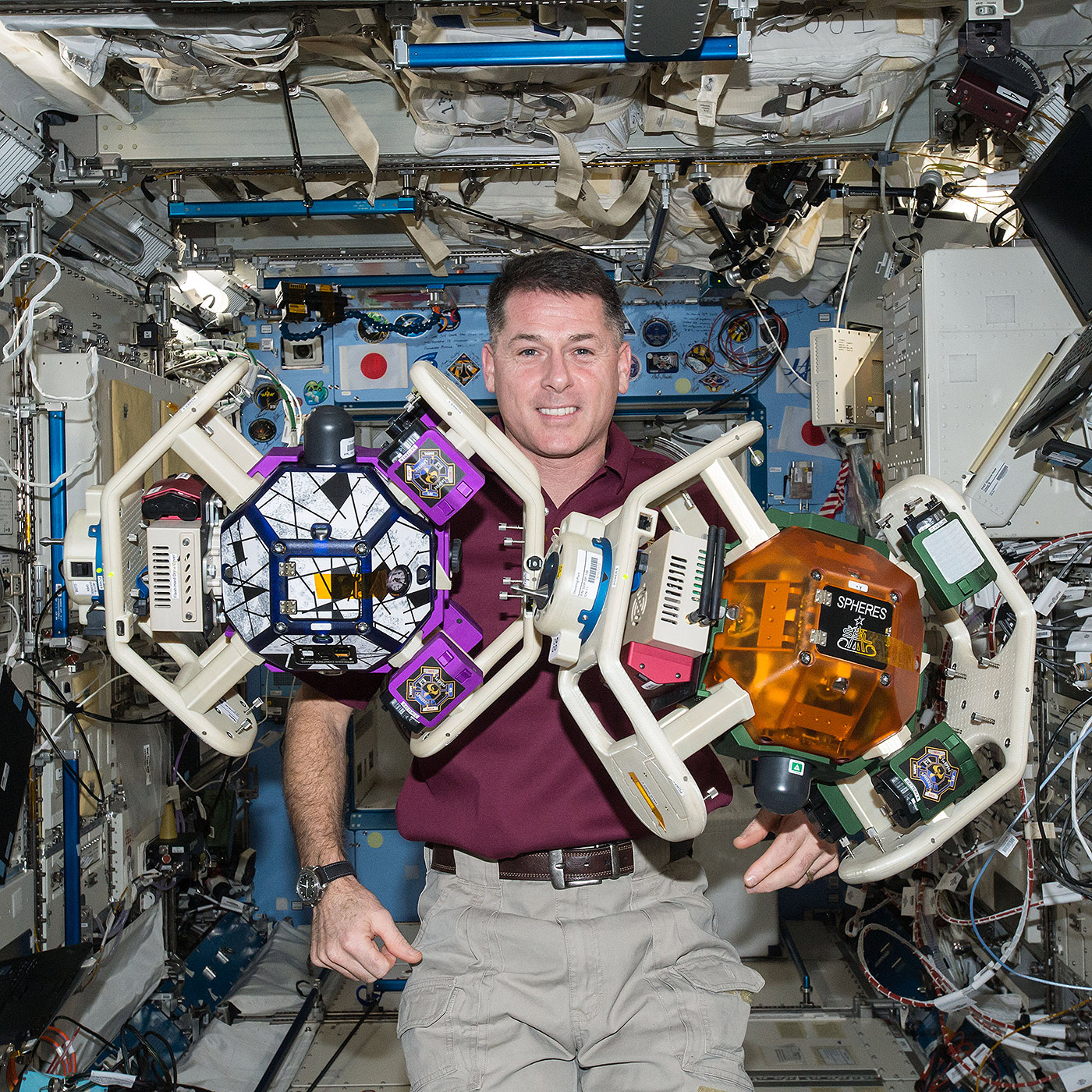 NASA astronaut Shane Kimbrough is seen executing the SPHERES RINGS experiment aboard the International Space Station. The investigation uses two small, self contained satellites (SPHERES) fitted with donut like rings (RINGS) to test wireless power transfer and formation flight using electromagnetic fields.