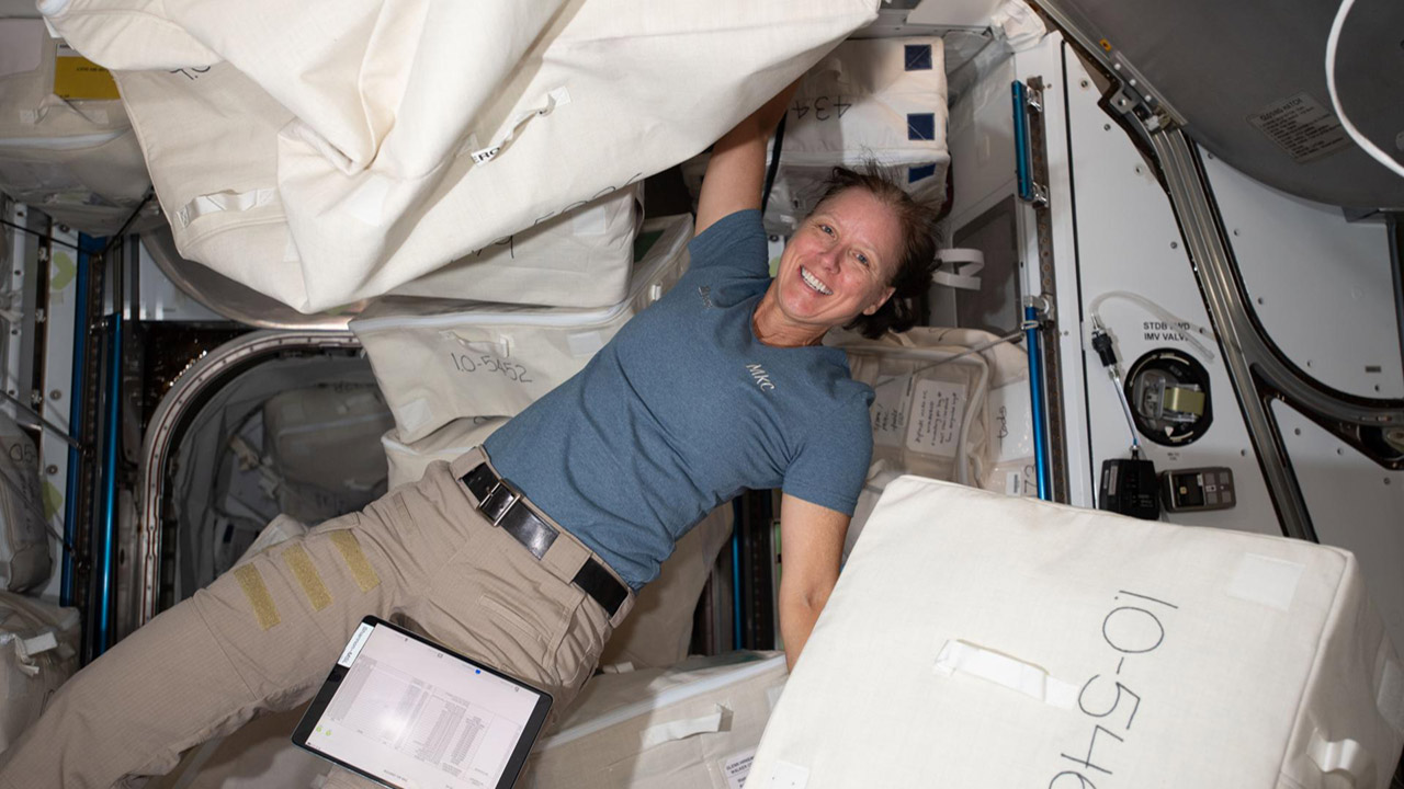 iss064e012018 (Dec. 14, 2020) NASA astronaut and Expedition 64 Flight Engineer Shannon Walker unpacks spacewalk hardware inside the Quest airlock where U.S. spacewalks are staged.
