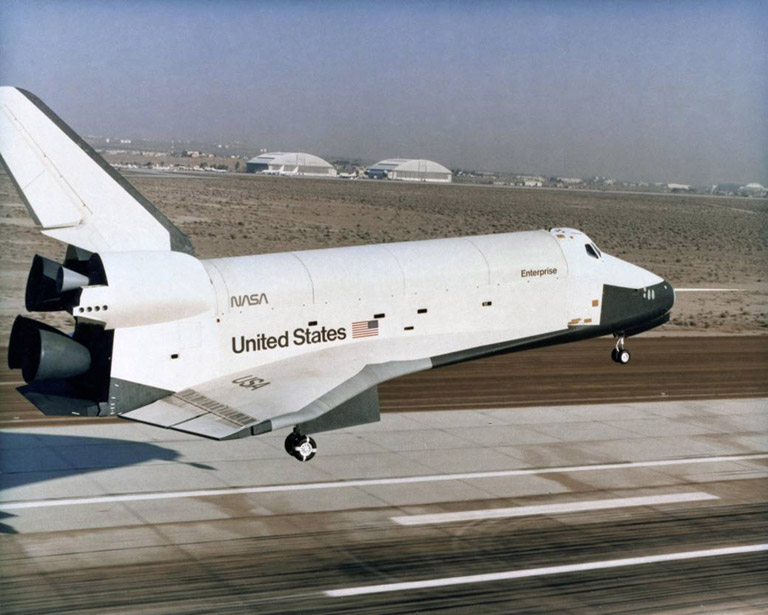EC77 8852 Piloted by astronauts Fred Haise and Gordon Fullerton, the prototype space shuttle Enterprise settles toward the main runway at Edwards Air Force Base on its final Approach and Landing Test flight on Oct. 26, 1977.
