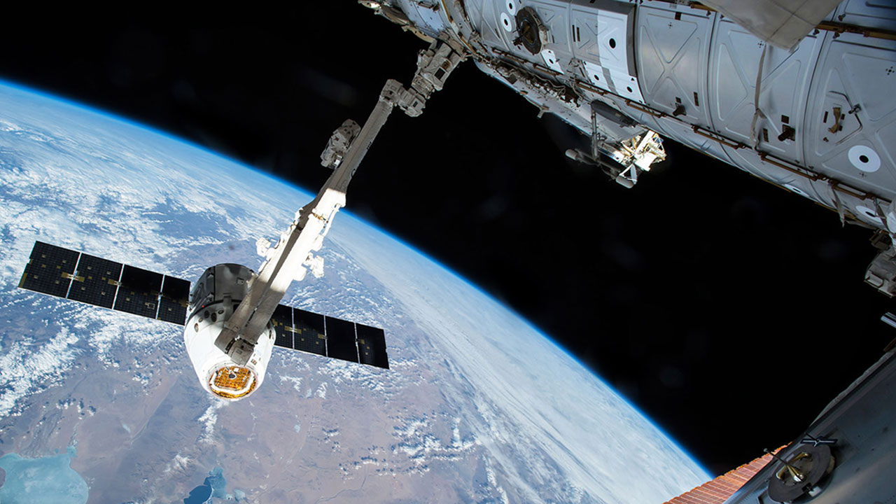 A SpaceX Dragon capsule is captured by Canadarm2 in August 2017.