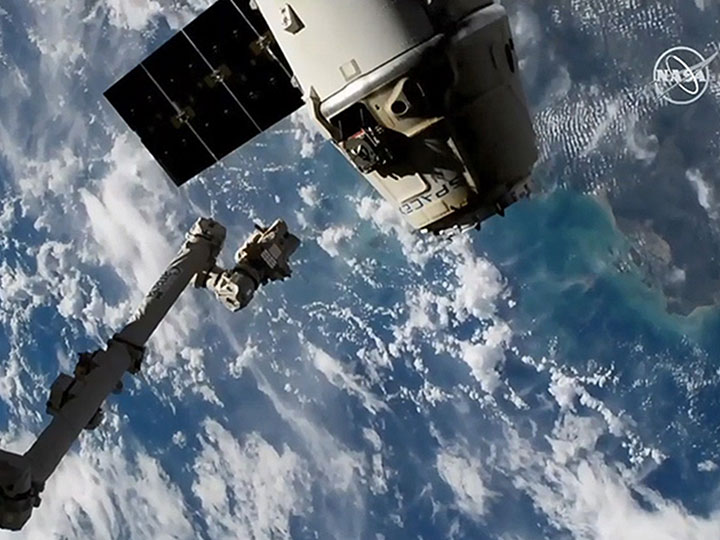 The SpaceX Dragon cargo craft is pictured moments after being released from the Canadarm2 robotic arm.
