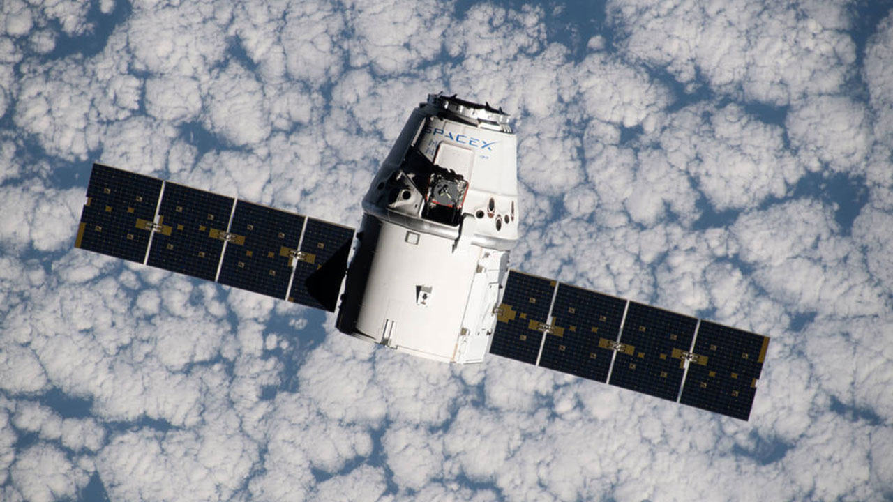 iss060e015838 (July 27, 2019) The SpaceX Dragon space freighter approaches the International Space Station as both spacecraft were orbiting 265 miles above the Atlantic Ocean off the west coast of Namibia.