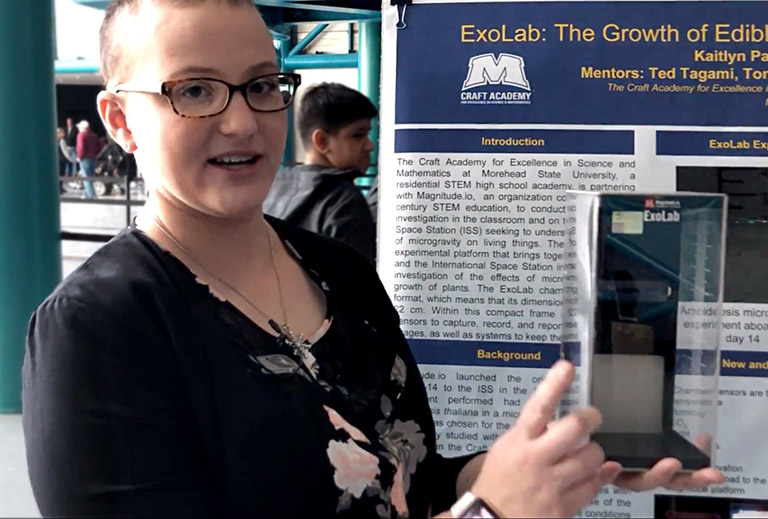 Kaitlyn Palumbo from Craft Academy presented a poster about her teams experiment with heat tolerant microgreens. Four plant growth chambers, lights, and sensors fit into a box the same size as the classroom ExoLab she displayed.
