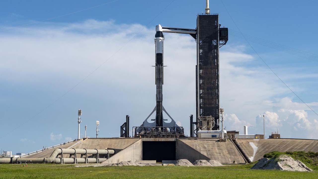 A SpaceX Falcon 9 rocket, with the companys Cargo Dragon spacecraft atop, is raised to a vertical position at NASA Kennedy Space Centers Launch Complex 39A on July 12, 2022, in preparation for the 25th commercial resupply services launch to the ISS.