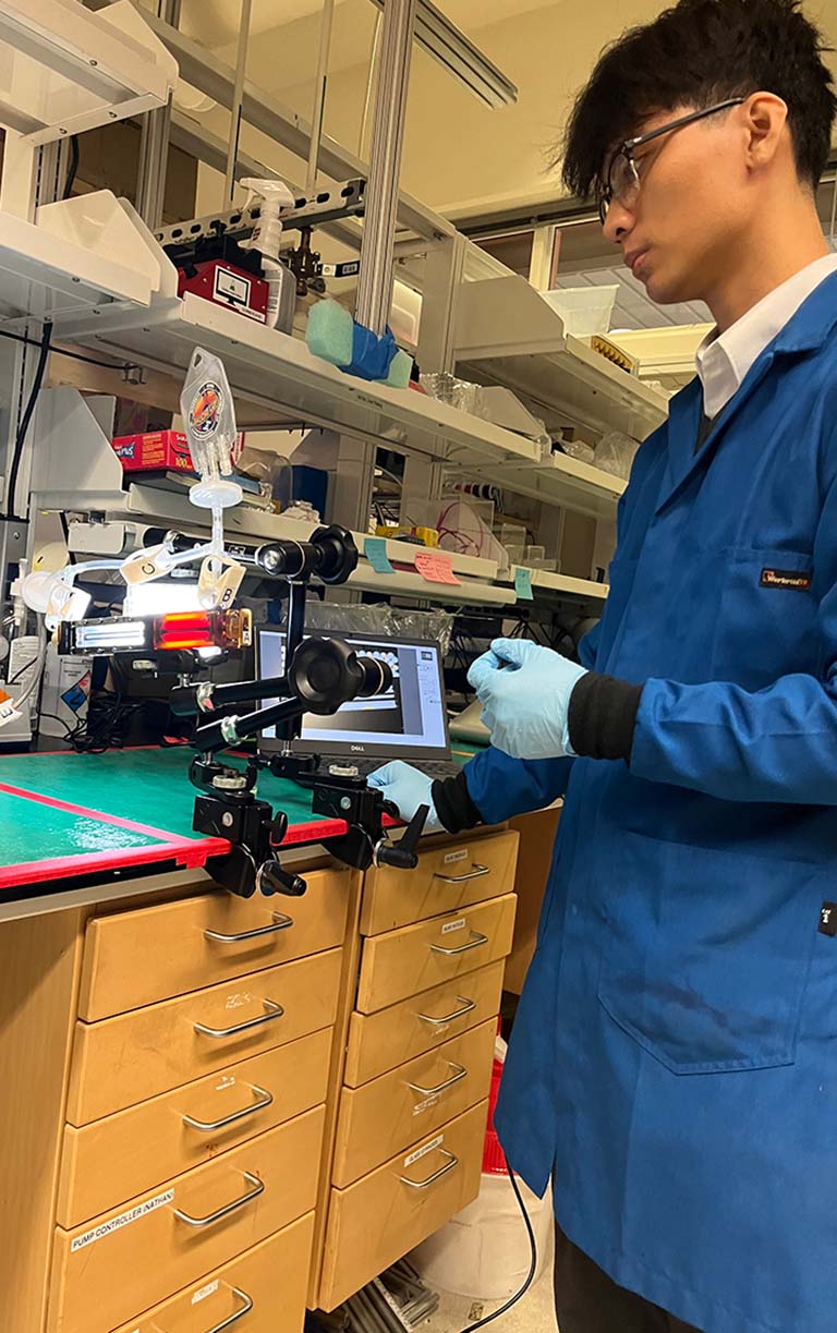 UCSB PhD student Trinh Huynh tests the experimental system that will fly onboard the ISS.