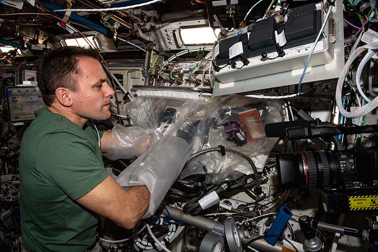 NASA astronaut Josh Casada helps with the Biofabrication Facility meniscus prints on the ISS.