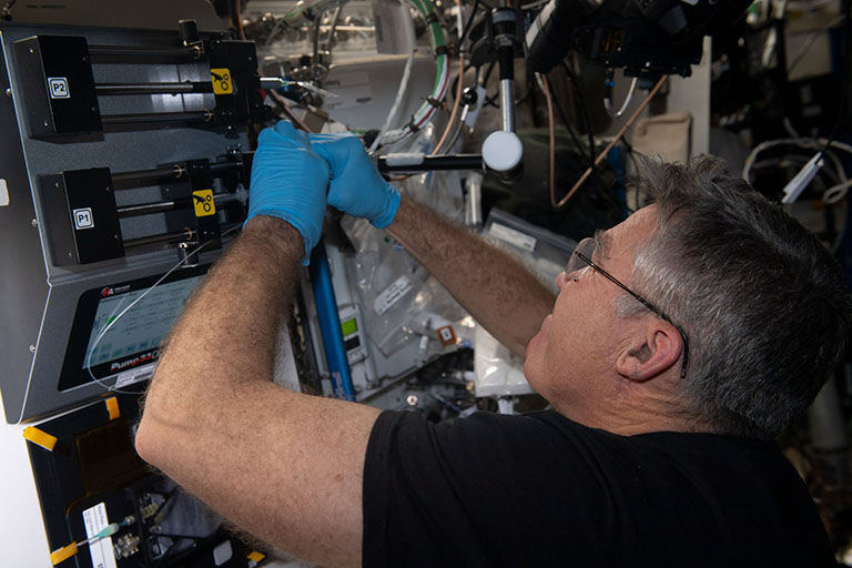 NASA astronaut Stephen Bowen works on the foams and emulsions payloads on the ISS.
