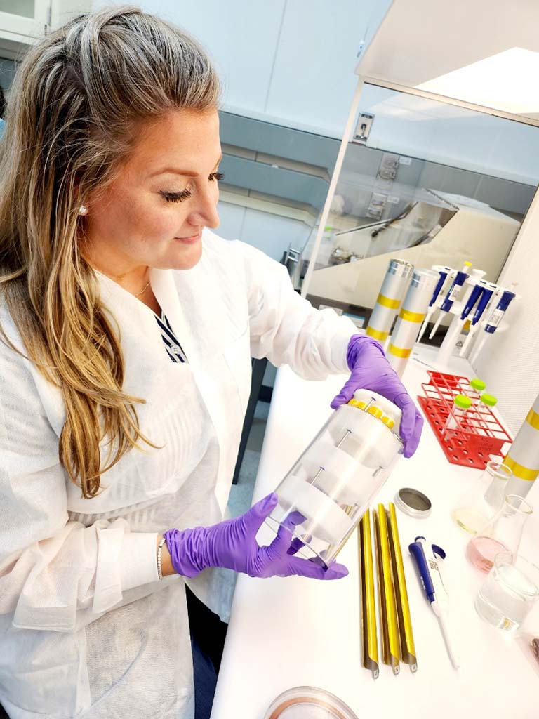 Olivia Gamez Holzhaus prepares the Rhodium DARPA Biomanufacturing 01 investigation for flight to the International Space Station. 
