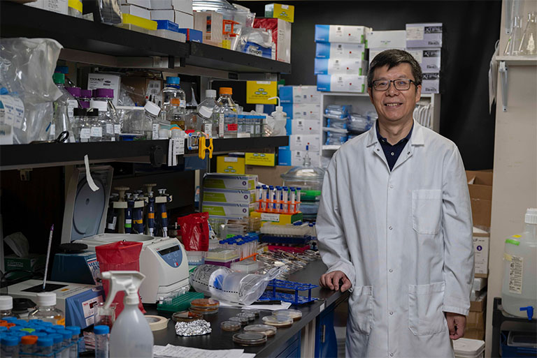 Zheng Wang, U.S. Naval Research Laboratory (NRL) research biologist, poses in NRLs Microbes for Multiple Uses in Space Project (MELSP) lab in Washington, D.C.
