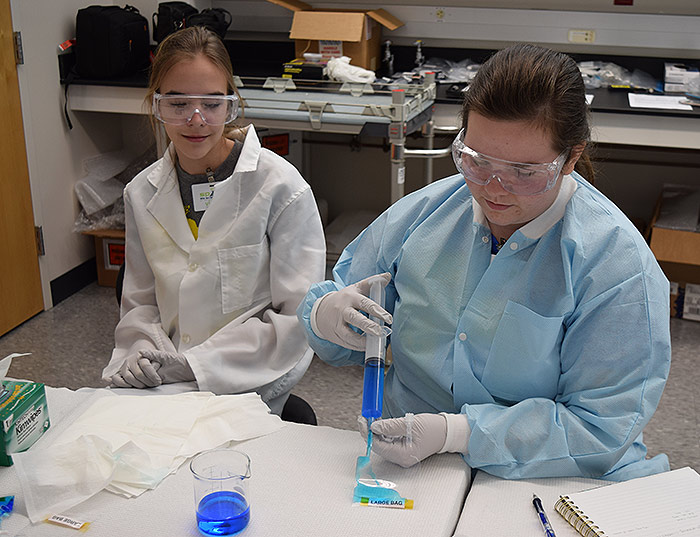 Students on the ground preparing samples