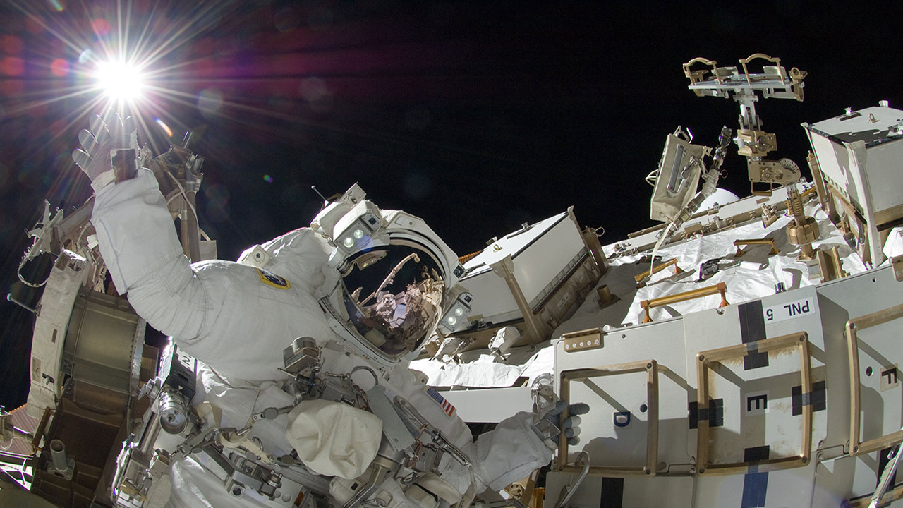 NASA astronaut Sunita Williams, Expedition 32 flight engineer, appears to touch the bright sun during the missions third session of extravehicular activity (EVA) on Sept. 5, 2012.