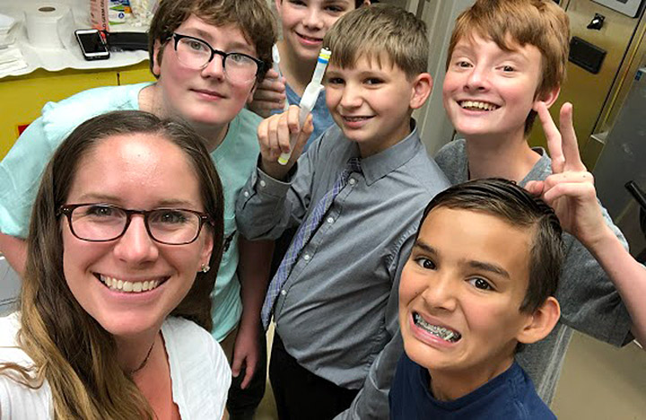 SSEP Team Penicillium Mold Growth (Ethan Moore, Ryder Huskins, Ian Ray, Kenneth Huskins, and Gabriel McCarthy), together with their teacher Laura Smith, prepare their MixStix sample to launch to the ISS National Lab for their SSEP experiment.
