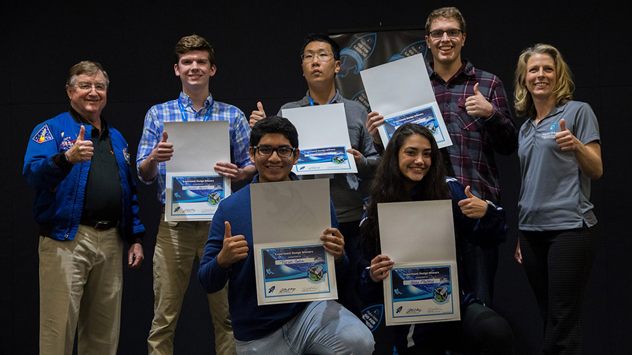 Left to right: Former NASA astronaut Frank Culbertson, the five Team Waffle students (Spencer Harris, Tarun Golla, George Tang, Abby Maltese, and Ryan Ferzoco), and Higher Orbits founder Michelle Lucas.