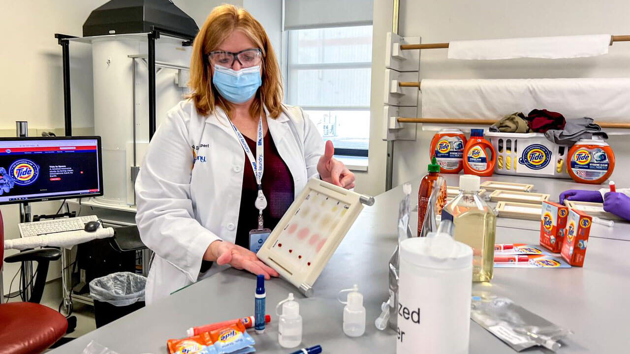 jsc2021e064548 ()11 30 2021) In support of P&G Telescience Investigation of Detergent Experiments (PGTIDE), Kristi Niehaus, Tide Scientist, Strategic Innovation & Technology at P&G, displays a stain set that will be used to test Tide detergent solutions on board the International Space Station National Labs in 2022 P&G Telescience Investigation of Detergent Experiments (PGTIDE). Following the signing of a Space Act Agreement with NASA, Tide is developing a detergent solution for space that will aid in planned space travel such as the Artemis Moon missions and a crewed roundtrip Mars mission. Image courtesy of P&G. Date Created: 2021 11 30