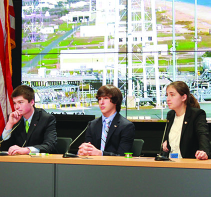 Lindbergh (far right) and Garvey (center), with collaborator Gabriel Voigt, discuss their research at an Orb 3 science briefing in October 2014.