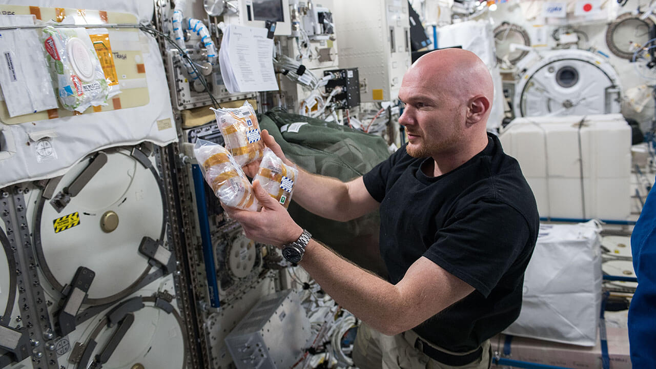 European Space Agency astronaut Alexander Gerst places Toledo Crystallization Boxes (TCBs) into storage onboard the ISS.