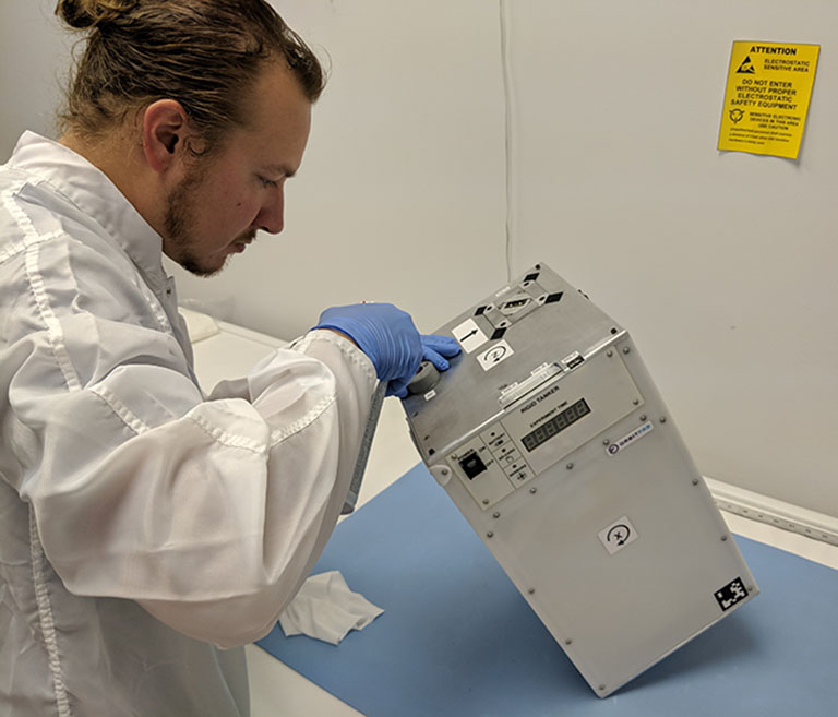 James Bultitude, Orbit Fabs chief technology officer, performs final cleaning and inspection of the rigid tanker during hardware handover to NASA before its flight to the ISS on SpaceX CRS 16.