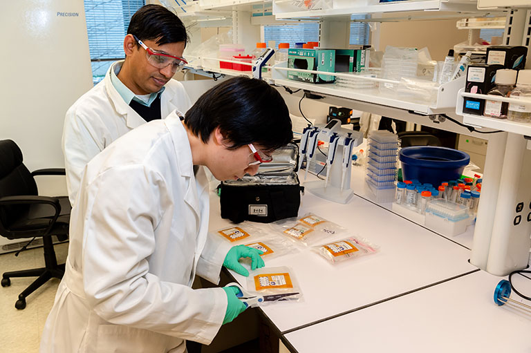 The Frederick National Lab team carefully opening samples returned from the ISS