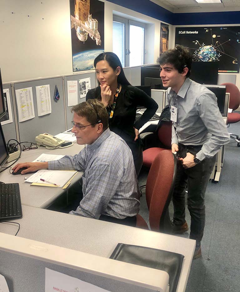 Ya Ting Liao, a researcher at Case Western Reserve University, is shown during operations at NASA Glenn Research Center as her experiment was underway onboard the space station. NASA researcher Paul Ferkul (left) and Jonah Sachs Wetstone (right), a then undergraduate student in Liaos lab, are also shown.