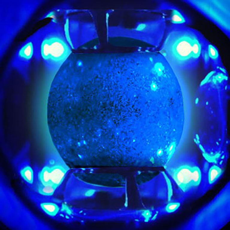 Human serum albumin drop under blue illumination in the Ring Sheared Drop system on the ISS.
