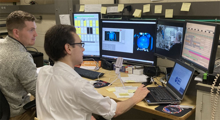 RPI postdoctoral researchers Joe Adam (right) and Partrick McMackin (left) commanding the investigation on station from their lab at RPI.