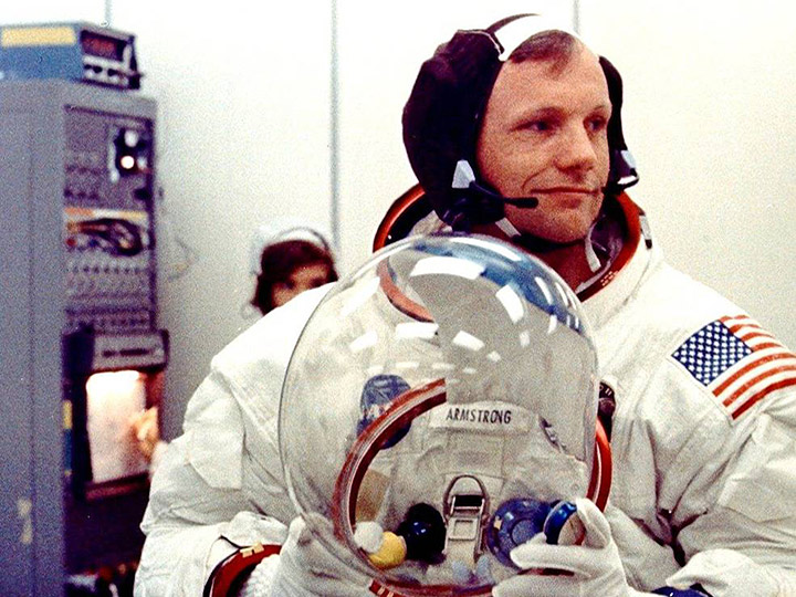 On the morning of July 16, 1969, Apollo 11 commander Neil Armstrong prepares to don his helmet in the suit up room of the crew quarters in the Kennedy Space Centers Manned Spacecraft Operations Building which will now bear his name.