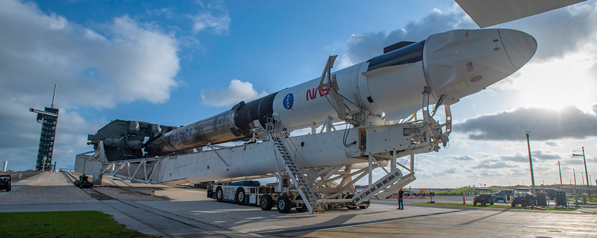 SpaceX’s Crew Dragon – named Freedom by the Crew-4 astronauts – atop the company’s Falcon 9 rocket, leaves the SpaceX integration hangar adjacent to NASA Kennedy Space Center’s Launch Complex 39A for rollout to the launch pad on April 19, 2022.
