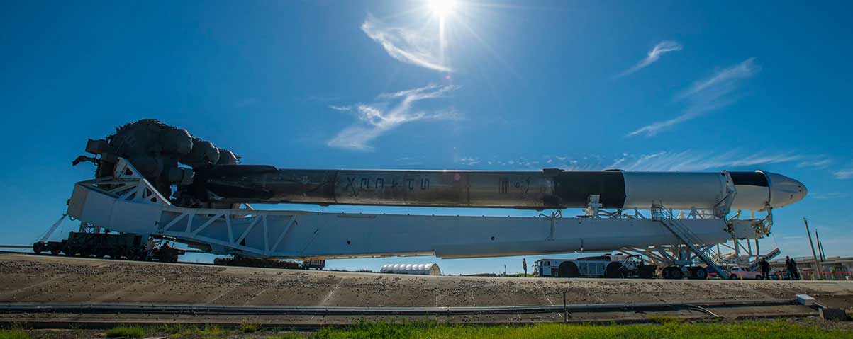 SpaceX’s Cargo Dragon spacecraft, seen atop the company’s Falcon 9 rocket, is rolled out to the launch pad at NASA’s Kennedy Space Center in Florida on July 12, 2022, in preparation for the 25th commercial resupply services launch.