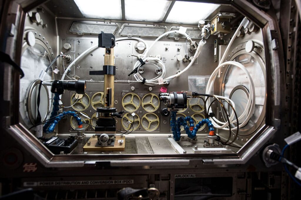 iss064e002379 (1/15/2017) --- Photo documentation of Inertial Spreading with Vibration and Water Coalescence (Drop Vibration) experiment hardware set up inside the Microgravity Science Glovebox (MSG) aboard the International Space Station (ISS). Inertial Spreading with Vibration and Water Coalescence (Drop Vibration) examines the behavior of big liquid drops whose perimeter of contact, called the contact line, moves rapidly as the drops change shape either forced by vibration or freely by merger. Image courtesy of NASA.