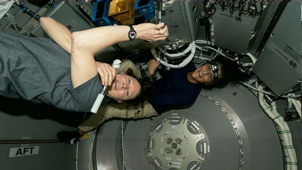 dyson-williams-bishop-airlock-argus NASA astronauts Tracy C. Dyson and Suni Williams work inside the Nanoracks Bishop Airlock on the ISS, installing the ArgUS Mission-1 hardware to test its external operations in space.