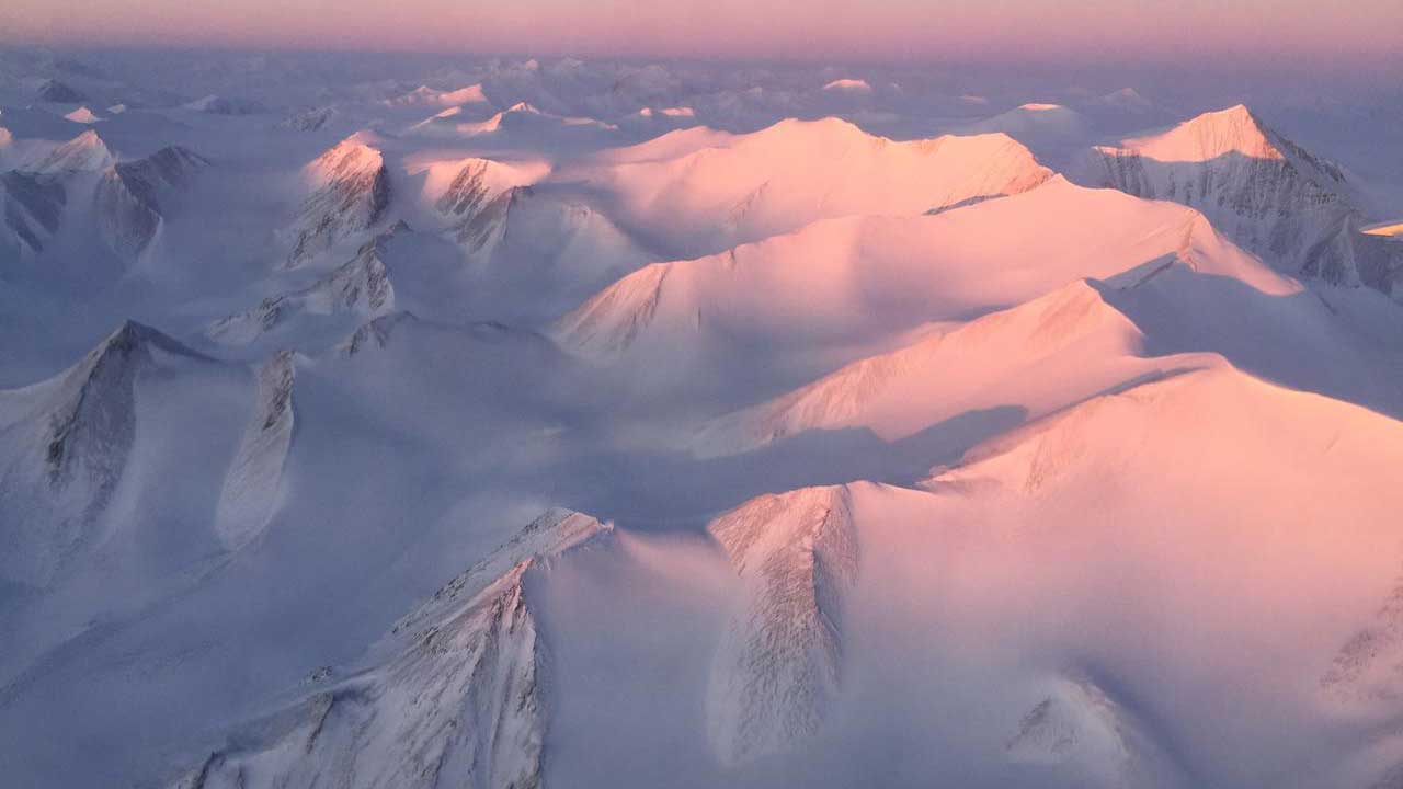 ellesmere-island-mountains-operation-icebridge Ellesmere Island mountain tops bathed in light as the sun began to peak over the horizon during Operation IceBridge’s first flight of its 2017 Arctic campaign, on March 9, 2017.
