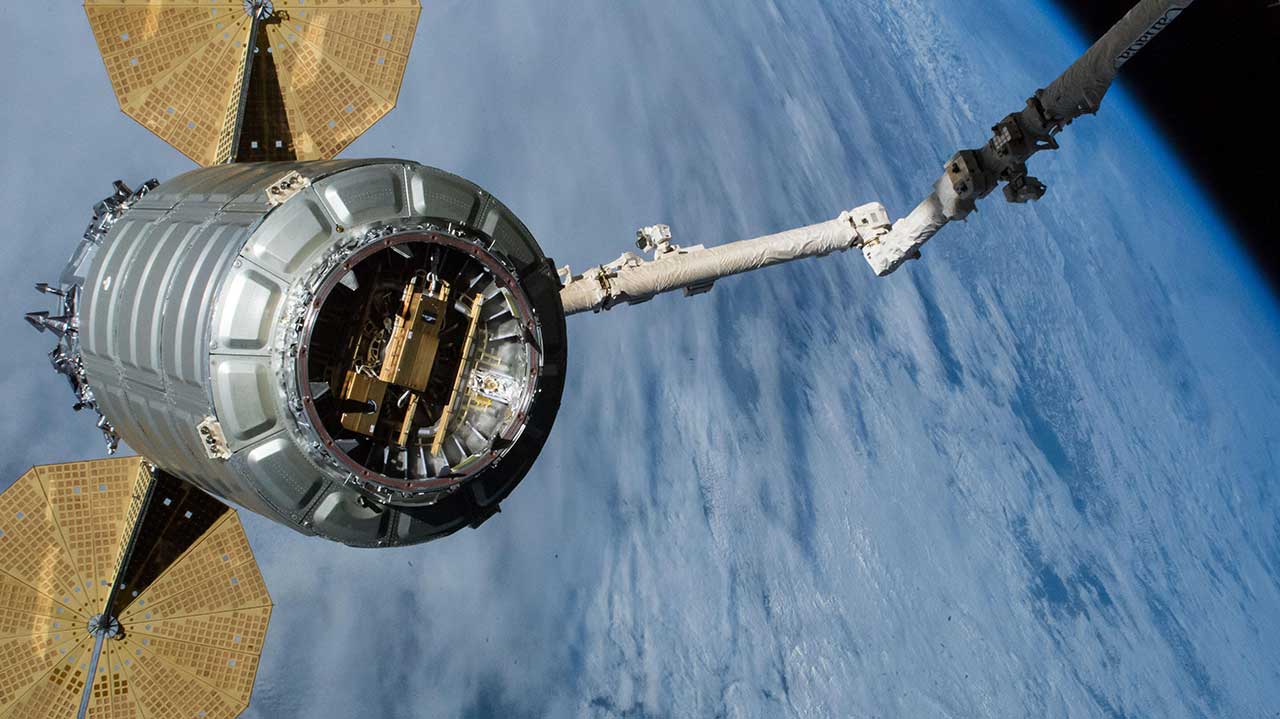 facilities-slingshot Visible in Cygnus' Common Berthing Mechanism is the Slingshot small satellite deployer designed to deploy CubeSats from the cargo ship once it reaches a safe distance from the station after its release.