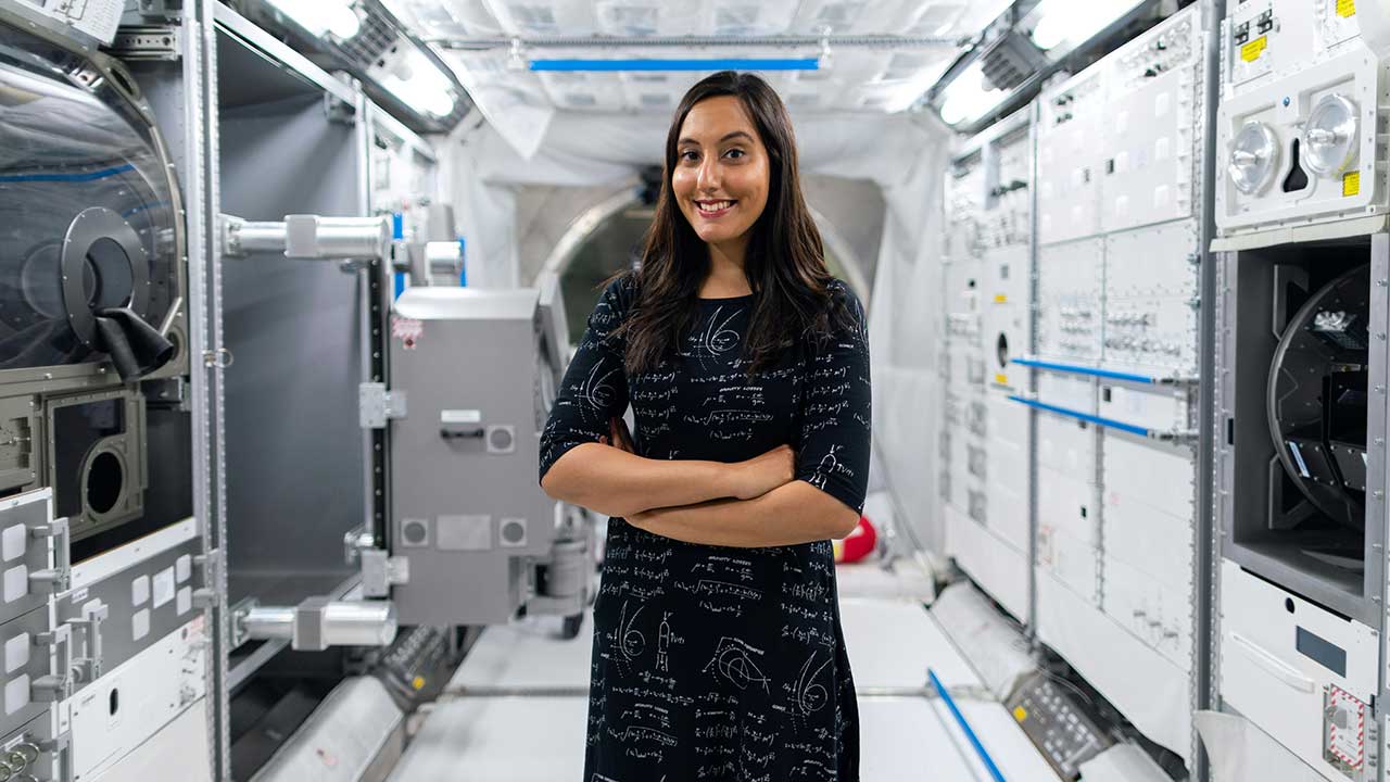 returning-principal-investigator Woman scientist in a mock up of the ISS