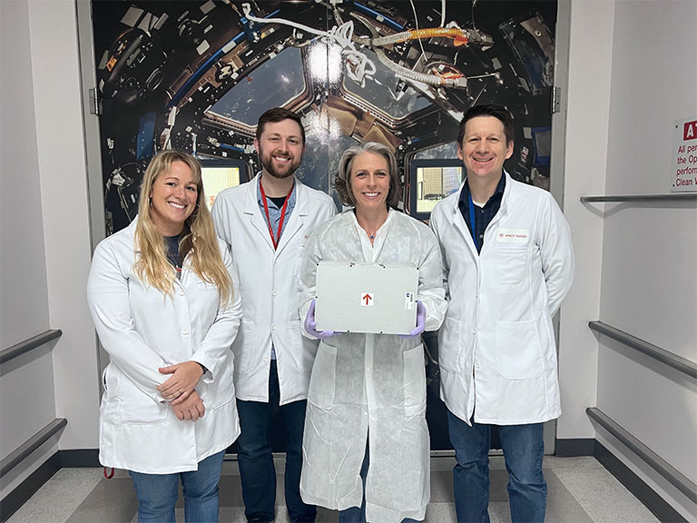 Space Tango scientists with Higher Orbits founder and CEO Michelle Lucas, who holds a CubeLab like the one used by Go For Launch! experiments.