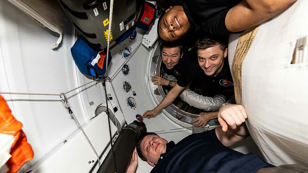 SpaceX Crew-8 astronauts-from top to bottom-NASA's Jeanette Epps, Mike Barratt, and Matthew Dominick, and Roscosmos cosmonaut Alexander Grebenkin onboard the ISS between the Harmony module's space-facing port and the SpaceX Dragon Endeavour spacecraft.