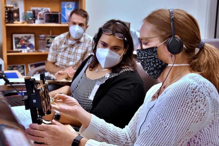 The BioServe team on console communicating with ISS crew members during in-orbit operations for MicroQuin's 3D cell culture experiment (right to left: Shela Nielsen, Shakini Doraisingam, and Matt Vellone).