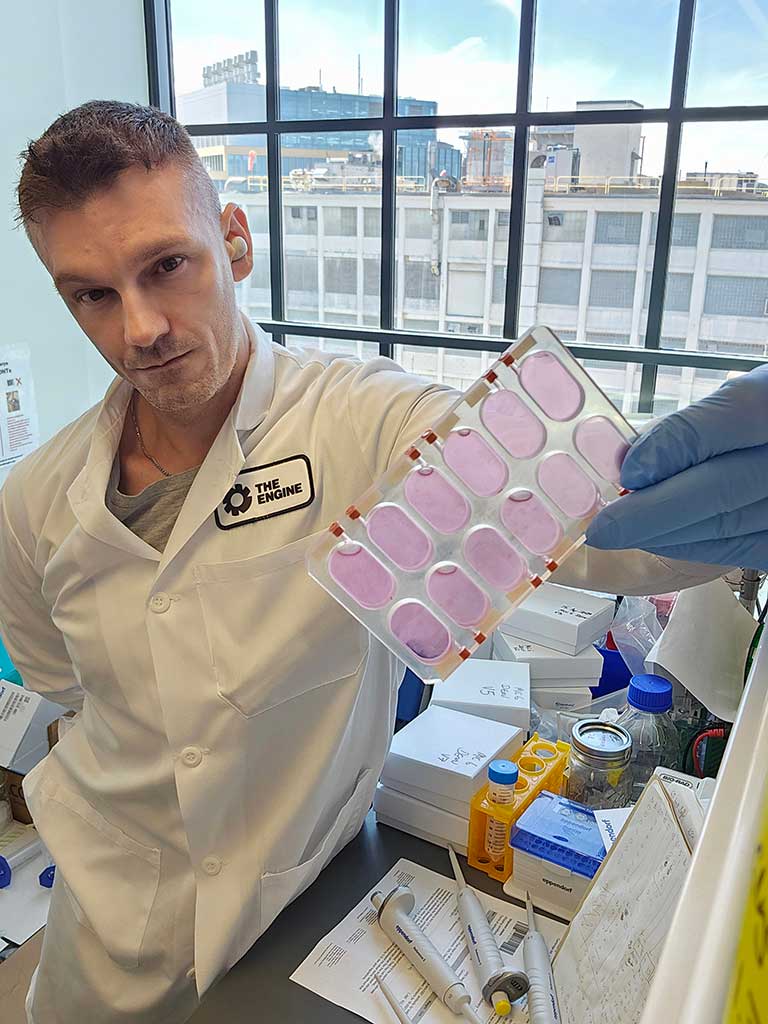 MicroQuin founder and CSO Scott Robinson, holding a specialized 12-well tissue culture plate containing breast cancer cells grown on the ISS.